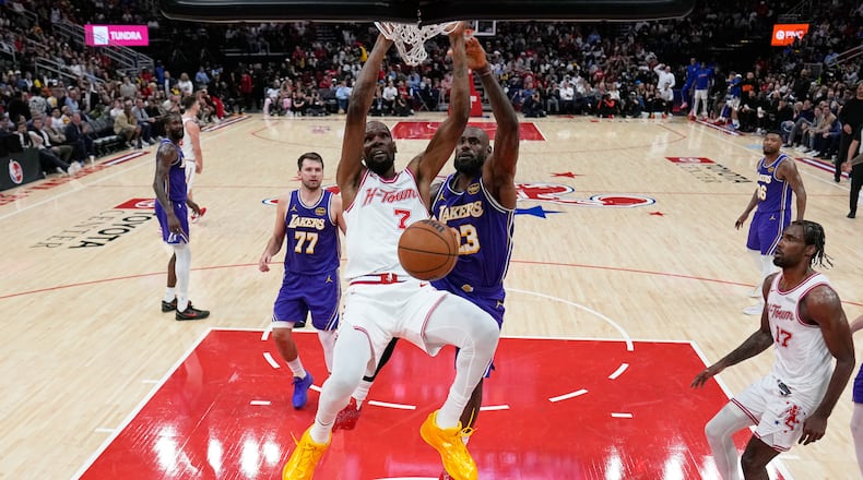 Houston Rockets' Kevin Durant (7) dunks the ball as Los Angeles Lakers' LeBron James (23) defends during the second half of an NBA basketball game Wednesday, March 18, 2026, in Houston. (AP Photo/David J. Phillip)