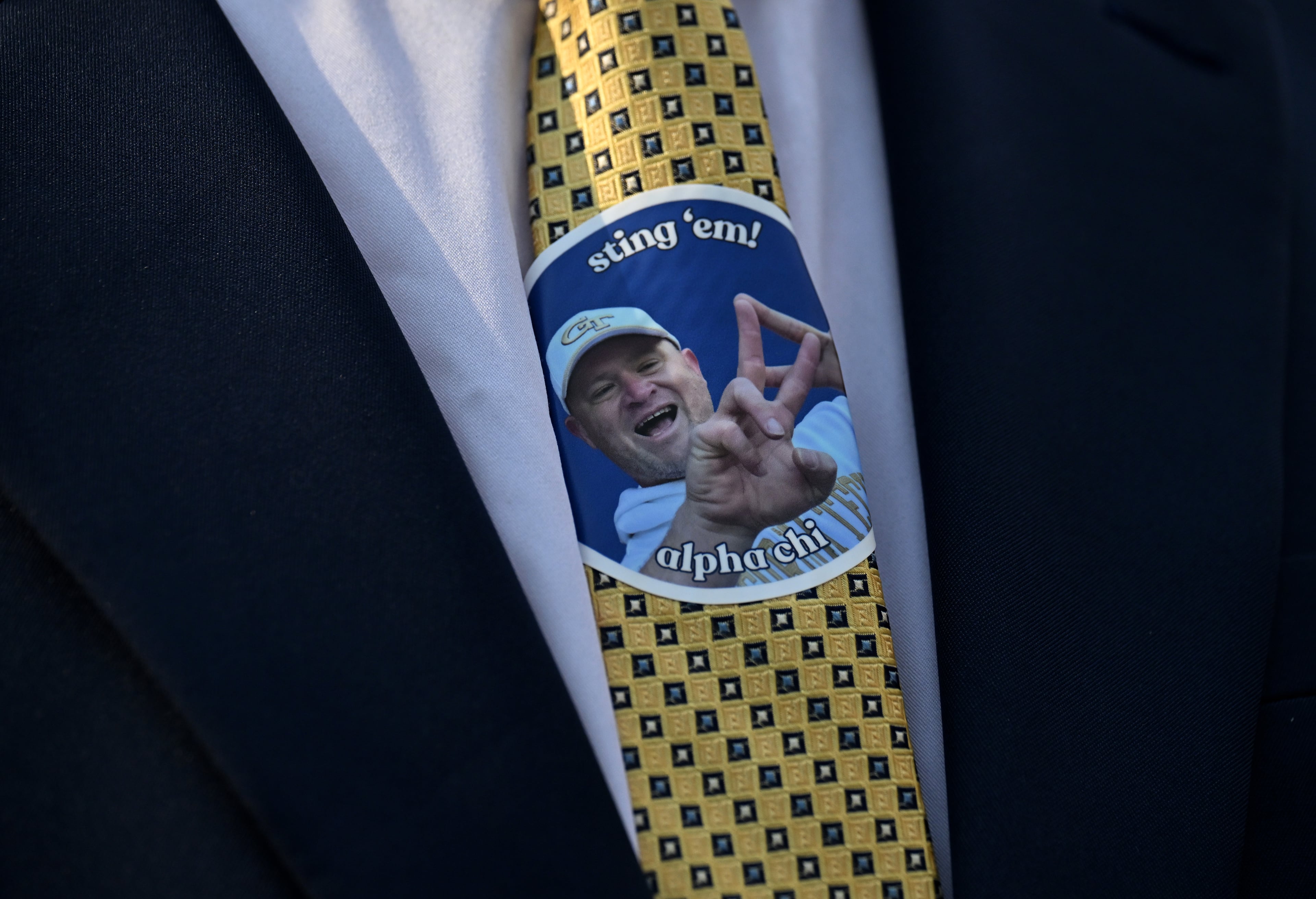 A Georgia Tech fan puts a sticker of head coach Brent Key on his tie during the first half of an NCAA college football game at Georgia Tech's Bobby Dodd Stadium, Saturday, Sept. 20, 2025 in Atlanta. (Hyosub Shin/AJC)