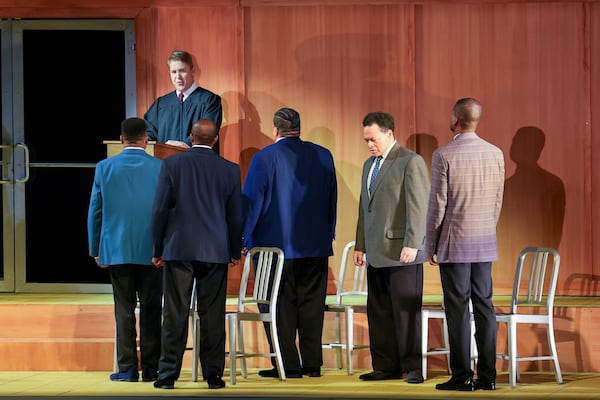 In this photo provided by the Detroit Opera, Daniel Belcher, top, sings the role of the Judge, in Anthony Davis's "The Central Park Five," and Markel Reed, from left, Freddie Ballentine, Chaz'men Willliams-Ali, Nathan Granner, and Justin Hopkins, portray the five teens at the center of the opera. (Austin T. Richey/Detroit Opera via AP)
