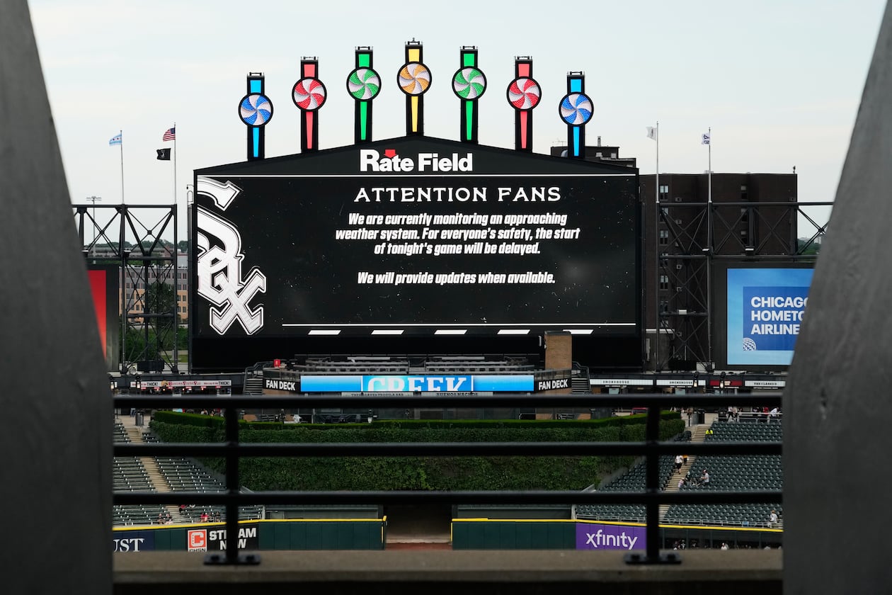 Information about rain delay displays on the big screen during a rain delay before a baseball game between the Atlanta Braves and the Chicago White Sox in Chicago, Thursday, June 11, 2026. (AP Photo/Nam Y. Huh)