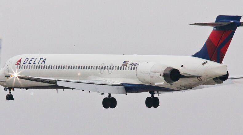 Secondary photo - January 14, 2015 Hartsfield-Jackson International Airport: A Delta jst takes off past the control tower Wednesday, Jan. 14, 2015. Hartsfield-Jackson International Airport has lost one of its two titles for world's busiest airport, with Chicago O'Hare taking the title for the most flights, according to year-end data from Flight Aware. Atlanta still carries millions more passengers, but for many years it held both titles. The decline in takeoffs and landings in Atlanta came as Delta Airlines retires regional jets and replaces them with larger planes, while Southwest Airlines cut back on AirTran flights here. JOHN SPINK / JSPINK@AJC.COM