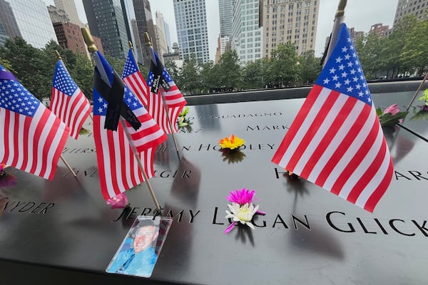 Flags and flowers were placed in the inscribed names at the National September 11 Memorial in New York on Wednesday.