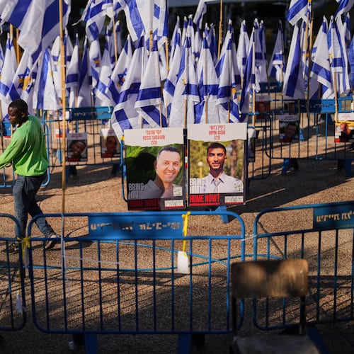 A worker cleans the ground at the plaza known as hostages square, in Tel Aviv, Israel, Tuesday, Oct. 14, 2025. (AP Photo/Francisco Seco)