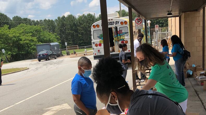 Gwinnett Bookmobile volunteers help students select books to keep at a recent stop at Shiloh Middle School. Photo contributed.