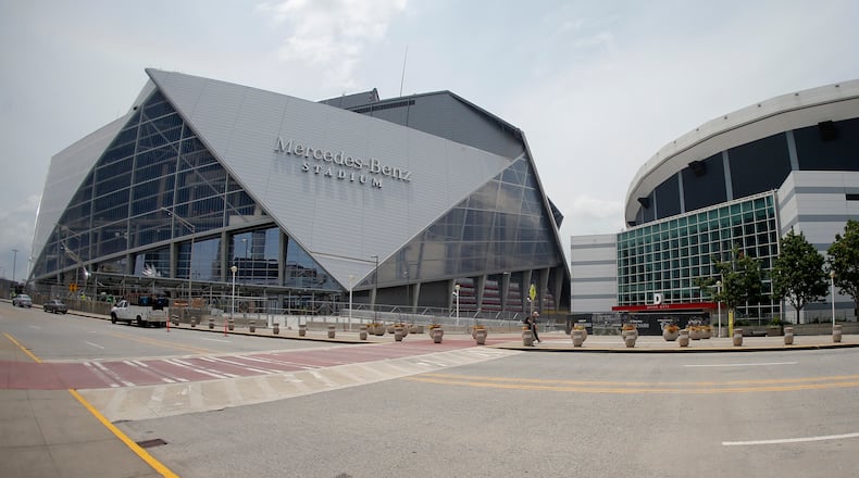 Mercedes Benz Stadium, left, the new home of the Atlanta Falcons football team and the Atlanta United soccer team, is shown next to the Georgia Dome Tuesday, July 25, 2017, in Atlanta. (AP Photo/John Bazemore)