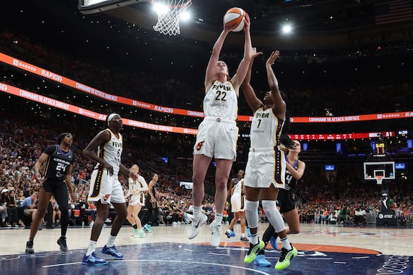 Indiana Fever's Caitlin Clark (22) grabs a rebound beside teammate Aliyah Boston (7) during the second half of a WNBA basketball game against the Connecticut Sun, Tuesday, July 15, 2025, in Boston. (AP Photo/Michael Dwyer)