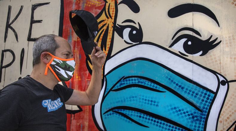 Neal Brandenburg walks by a mural painted by artist Sara Sandoval on Traction Avenue near 3rd Street in Los Angeles. (Mel Melcon / Los Angeles Times/TNS)