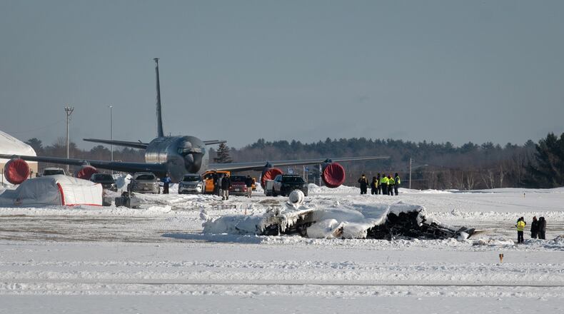 Investigators from the Federal Aviation Administration and National Transportation Safety Board investigate a plane crash at Bangor International Airport Wednesday, Jan. 28, 2026 in Bangor, Maine. (Linda Coan O'Kresik/The Bangor Daily News via AP)