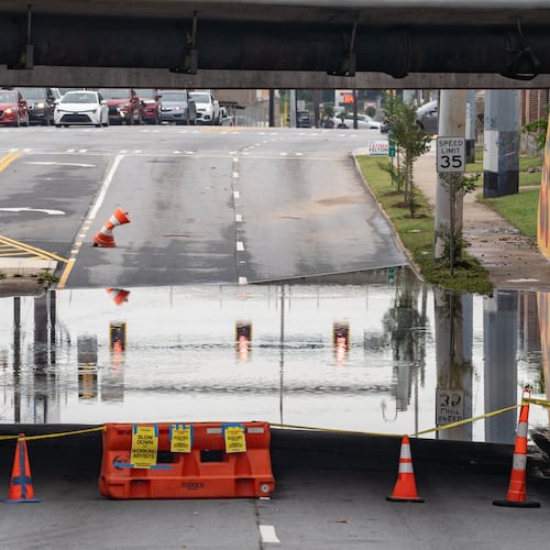 The southbound side of Northside Drive near Whitehall Street in Atlanta remains closed because of standing water Thursday morning after rain showers Wednesday. North Georgia will see more rain in the coming days, possibly causing more flooding. (Ben Hendren for the AJC)