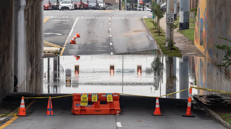 The southbound side of Northside Drive near Whitehall Street in Atlanta remains closed because of standing water Thursday morning after rain showers Wednesday. North Georgia will see more rain in the coming days, possibly causing more flooding. (Ben Hendren for the AJC)