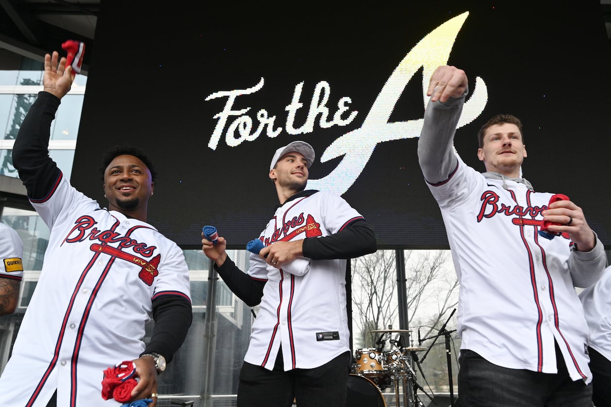 Atlanta Braves (from left) second baseman Ozzie Albies, first baseman Matt Olson and catcher Sean Murphy throw free t-shirts to fans at Georgia Power Pavilion Stage during Braves Fest Opening Rally at The Battery Atlanta, Saturday, January 27, 2024, in Atlanta. (Hyosub Shin/AJC)