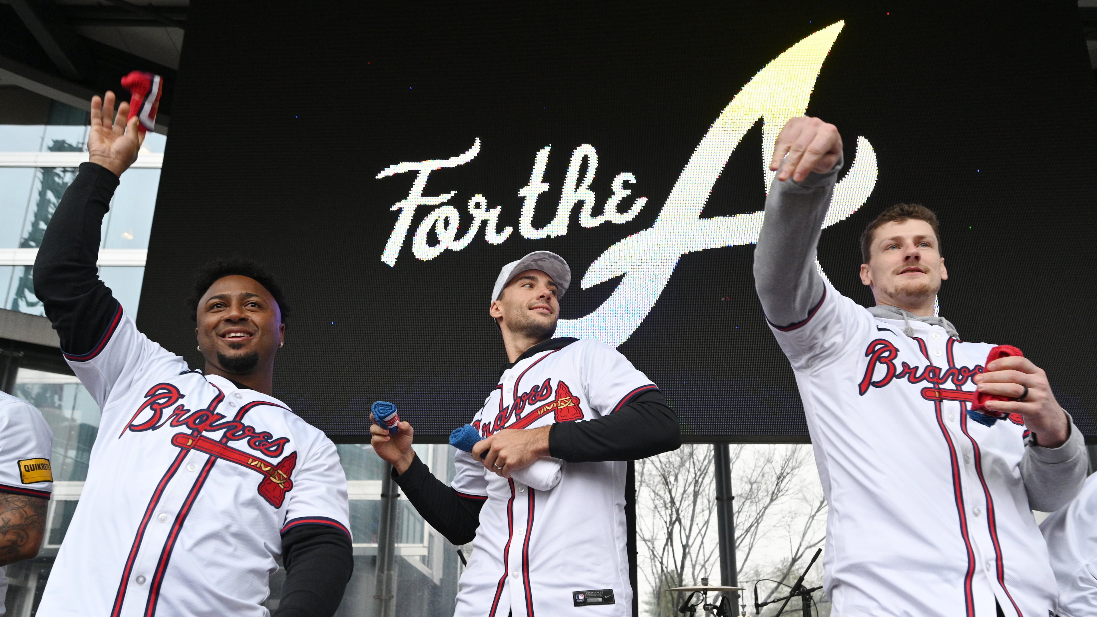 Atlanta Braves (from left) second baseman Ozzie Albies, first baseman Matt Olson and catcher Sean Murphy throw free t-shirts to fans at Georgia Power Pavilion Stage during Braves Fest Opening Rally at The Battery Atlanta, Saturday, January 27, 2024, in Atlanta. (Hyosub Shin/AJC)