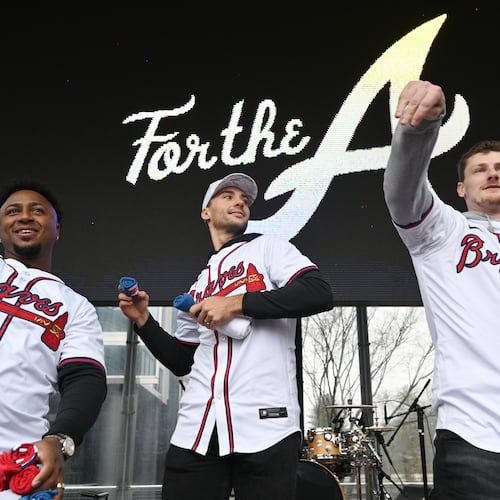 Atlanta Braves (from left) second baseman Ozzie Albies, first baseman Matt Olson and catcher Sean Murphy throw free t-shirts to fans at Georgia Power Pavilion Stage during Braves Fest Opening Rally at The Battery Atlanta, Saturday, January 27, 2024, in Atlanta. (Hyosub Shin/AJC)