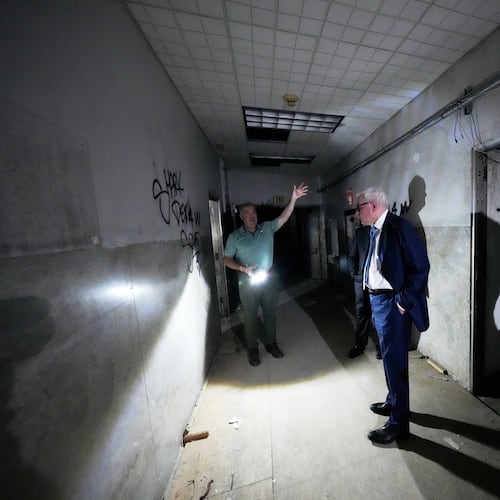 Patrick Norton, Tulane University senior vice president, chief operating officer and treasurer, right, and Jeff Benjamin, vice president of facilities and campus development, talk in a hallway inside the old Charity Hospital building Wednesday, Aug. 19, 2026, in New Orleans. (AP Photo/Gerald Herbert)