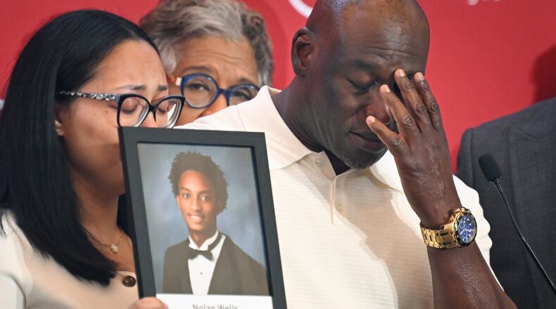 Elmore Wonsley, right, pauses from speaking as wife Christine Wonsley holds a photo of her deceased son, Nolan Wells, as they appear at the National Urban League's annual conference, Thursday, July 30, 2026, in Nashville, Tenn. (AP Photo/John Amis)