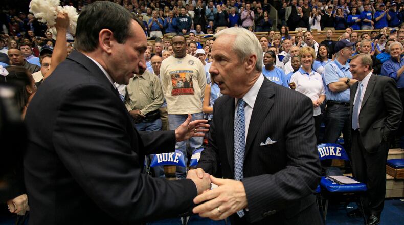 Duke coach Mike Krzyzewski, left, and North Carolina coach Roy Williams saw their programs among those listed in the FBI’s investigation into college basketball.