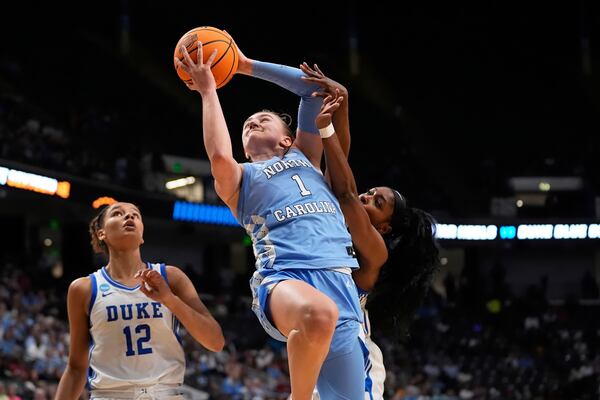 North Carolina guard Alyssa Ustby (1) goes to the basket against Duke guard Oluchi Okananwa during the first half in the Sweet 16 of the NCAA college basketball tournament, Friday, March 28, 2025, in Birmingham, Ala. (AP Photo/Gerald Herbert)