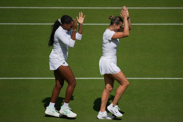 Aryna Sabalenka of Belarus, right, and Coco Gauff of United States during a practice session ahead of the Wimbledon Championships in London, Friday, June 27, 2025. (AP Photo/Kin Cheung)