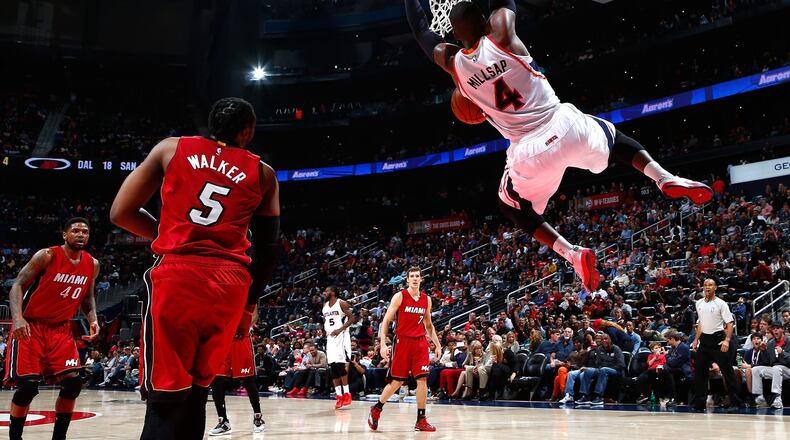 The Hawks’ Paul Millsap dunks off an alley-oop pass against the Heat’s Henry Walker during a game at Philips Arena. (Photo by Kevin C. Cox/Getty Images)