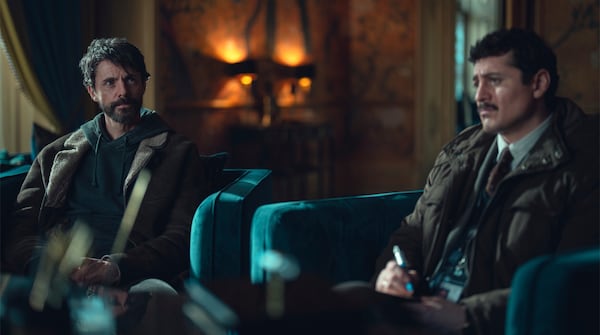 This image released by Netflix shows Matthew Goode, left, and Alexej Manvelov in a scene from the series "Dept. Q." (Netflix via AP)