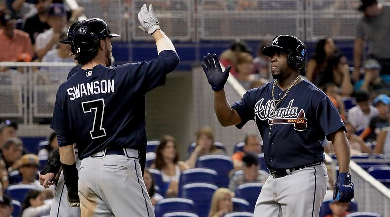 MIAMI, FL - OCTOBER 01: Adonis Garcia #13 of the Atlanta Braves is congratulated after hitting a three run home run in the seventh inning during a game against the Miami Marlins at Marlins Park on October 1, 2017 in Miami, Florida. (Photo by Mike Ehrmann/Getty Images)