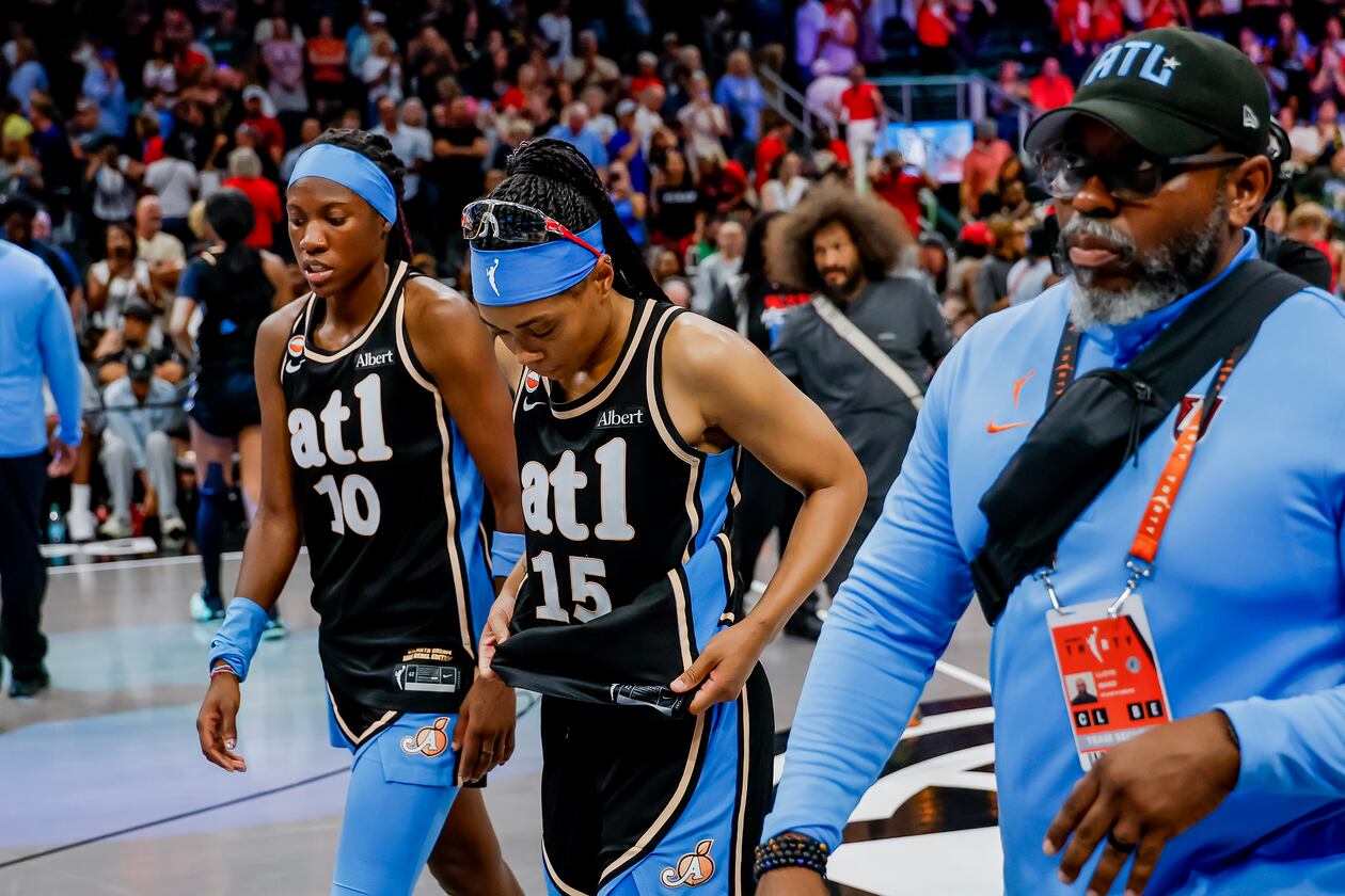 Atlanta Dream guard Allisha Gray (15) and guard Rhyne Howard (10) walks off the court after losing to the Indiana Fever in overtime of a WNBA game between the Atlanta Dream and the Indiana Fever, Sunday, Aug. 16, 2026, in Atlanta. (Erik S. Lesser for the AJC)