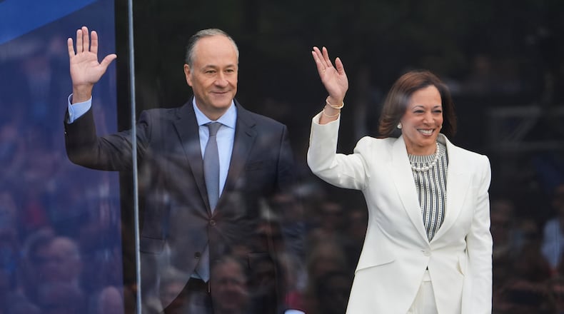 FILE - Former Vice President Kamala Harris and her husband Doug Emhoff arrive on stage during the dedication ceremony for the Obama Presidential Center, on June 18, 2026, in Chicago. (AP Photo/Jeff Roberson, File)