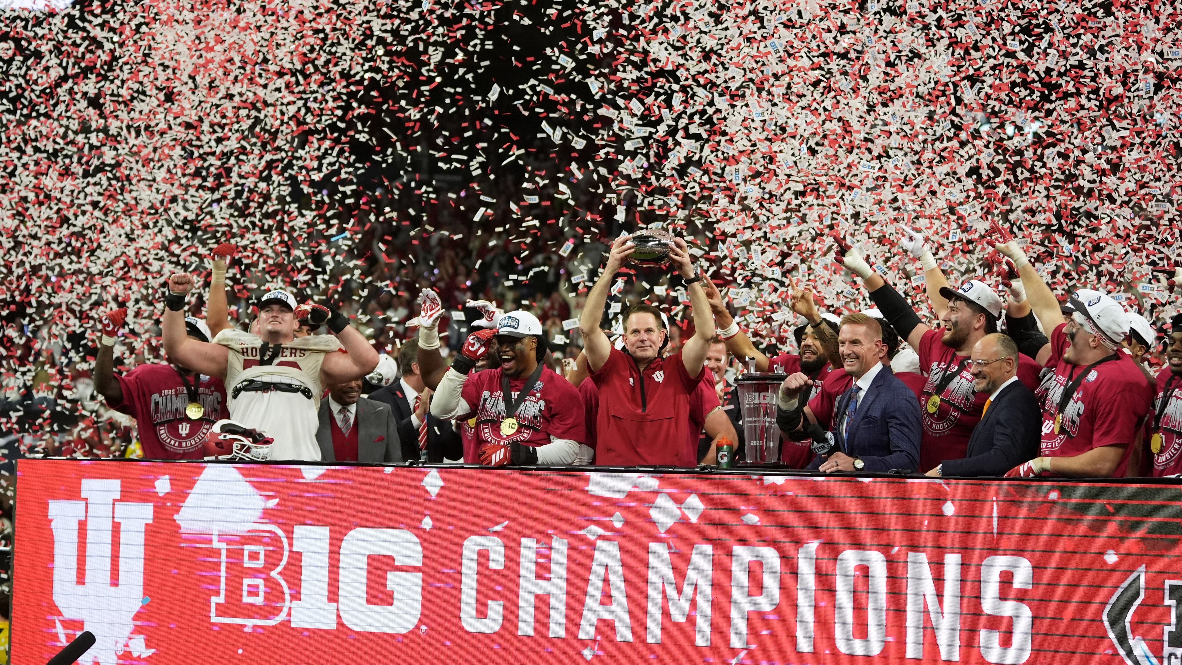 Indiana head coach Curt Cignetti holds the cahampionship trophy after the Big Ten championship NCAA college football game against Ohio State in Indianapolis, Saturday, Dec. 6, 2025. (AP Photo/Michael Conroy)