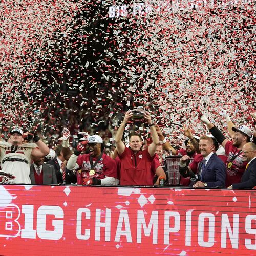 Indiana head coach Curt Cignetti holds the cahampionship trophy after the Big Ten championship NCAA college football game against Ohio State in Indianapolis, Saturday, Dec. 6, 2025. (AP Photo/Michael Conroy)