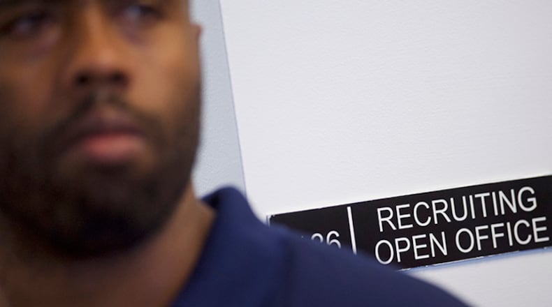 Job seekers wait for an interview during an Amazon jobs fair. The e-commerce behemoth is one of the employers that has been adding through the pandemic.