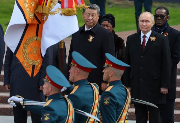 Chinese President Xi Jinping (left) and Russian President Vladimir Putin attend a wreath laying ceremony at the Tomb of the Unknown Soldier in Alexander Garden after the Victory Day military parade in Moscow in May. (Yuri Kochetkov/Pool Photo via AP)