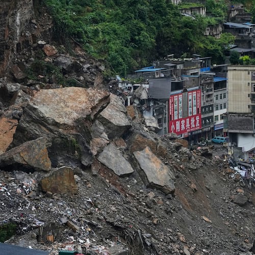 Residential and business buildings damaged by fallen rocks and mud are seen after a landslide in Pengshui County in southwestern China's Chongqing on Saturday, July 18, 2026. (AP Photo/Andy Wong)