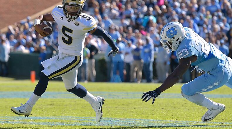 Justin Thomas of the Georgia Tech Yellow Jackets rolls out under pressure from Cayson Collins #23 of the North Carolina Tar Heels during the game at Kenan Stadium on November 5, 2016 in Chapel Hill, North Carolina. (Photo by Grant Halverson/Getty Images)