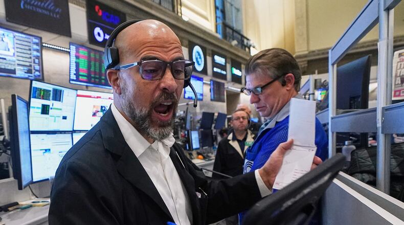 Options trader Steven Rodriguez, left, works on the floor of the New York Stock Exchange, Monday, Nov. 24, 2025. (AP Photo/Richard Drew)