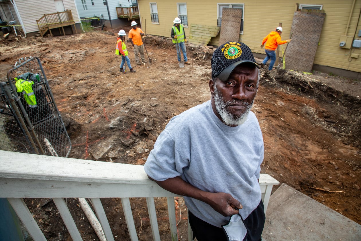 Ellis Smith stands on his porch last week as workers remove dirt from a Westside lead Superfund site in Atlanta's Vine City neighborhood. The cleanup of Smith’s yard is part of a massive EPA effort underway to remove lead from hundreds of Vine City properties, which comprise the Westside Lead Superfund site. (Steve Schaefer for The Atlanta Journal-Constitution)