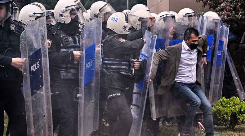 Police officers storm Turkey's main opposition Republican People's Party (CHP) headquarters to evict supporters gathered inside for party leader Ozgur Ozel, in Ankara, Sunday, May 24, 2026. (AP Photo/Ali Unal)