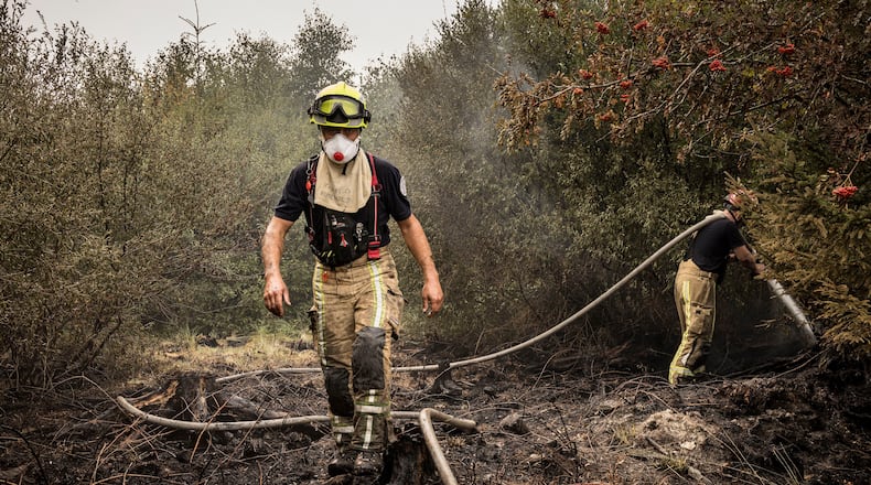 Firefighter work to extinguish wildfires at Hautes Fagnes near Waimes, Belgium, Sunday, Aug. 16, 2026. (Photo AP/Valentin Bianchi)