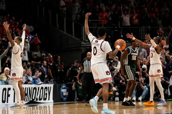 Auburn celebrates a win over Michigan State after the Elite Eight of the NCAA college basketball tournament, Sunday, March 30, 2025, in Atlanta. (AP Photo/George Walker IV)