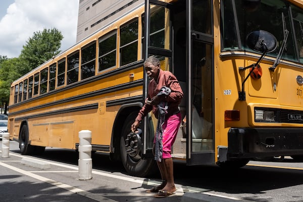 A bus drops off over 20 unhoused persons at Welcome House after they are relocated from Old Wheat Street. Thursday, July 10, 2025. (Ben Hendren for the AJC)