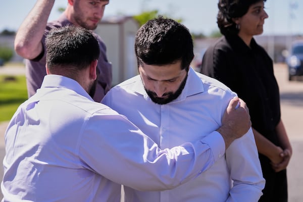 A supporter who identified himself as Palestinian is hugged by a fellow supporter after speaking at a news conference outside the Central Louisiana ICE Processing Center in Jena, La., after an immigration hearing for Mahmoud Khalil, the Columbia University activist facing deportation for his role in pro-Palestinian campus protests, Friday, April 11, 2025. (AP Photo/Gerald Herbert)