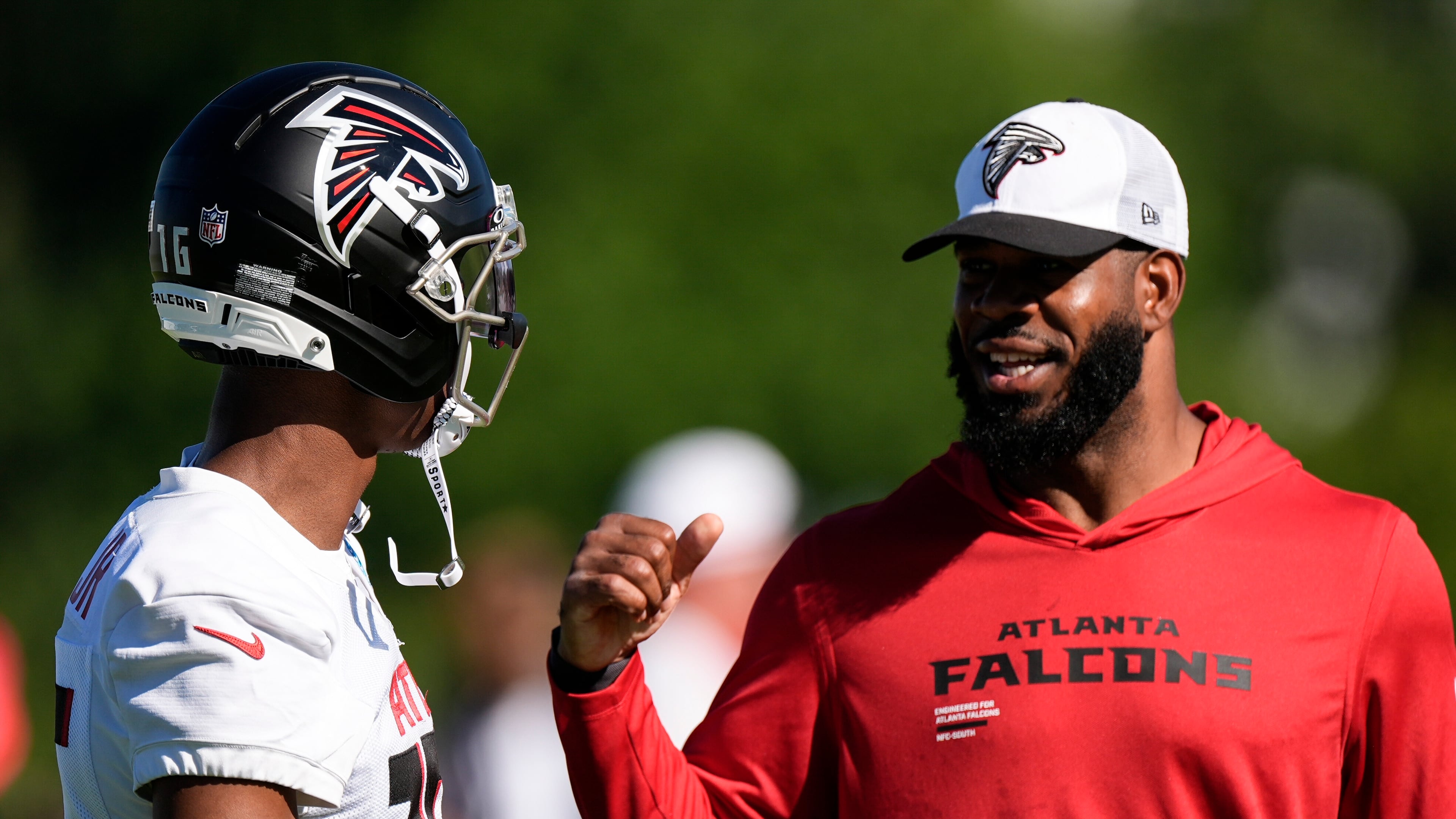 Falcons wide receiver DJ Chark Jr. (left) speaks to tight ends coach Kevin Koger during training camp on Saturday, July 26, 2025, in Flowery Branch. (Mike Stewart/AP)