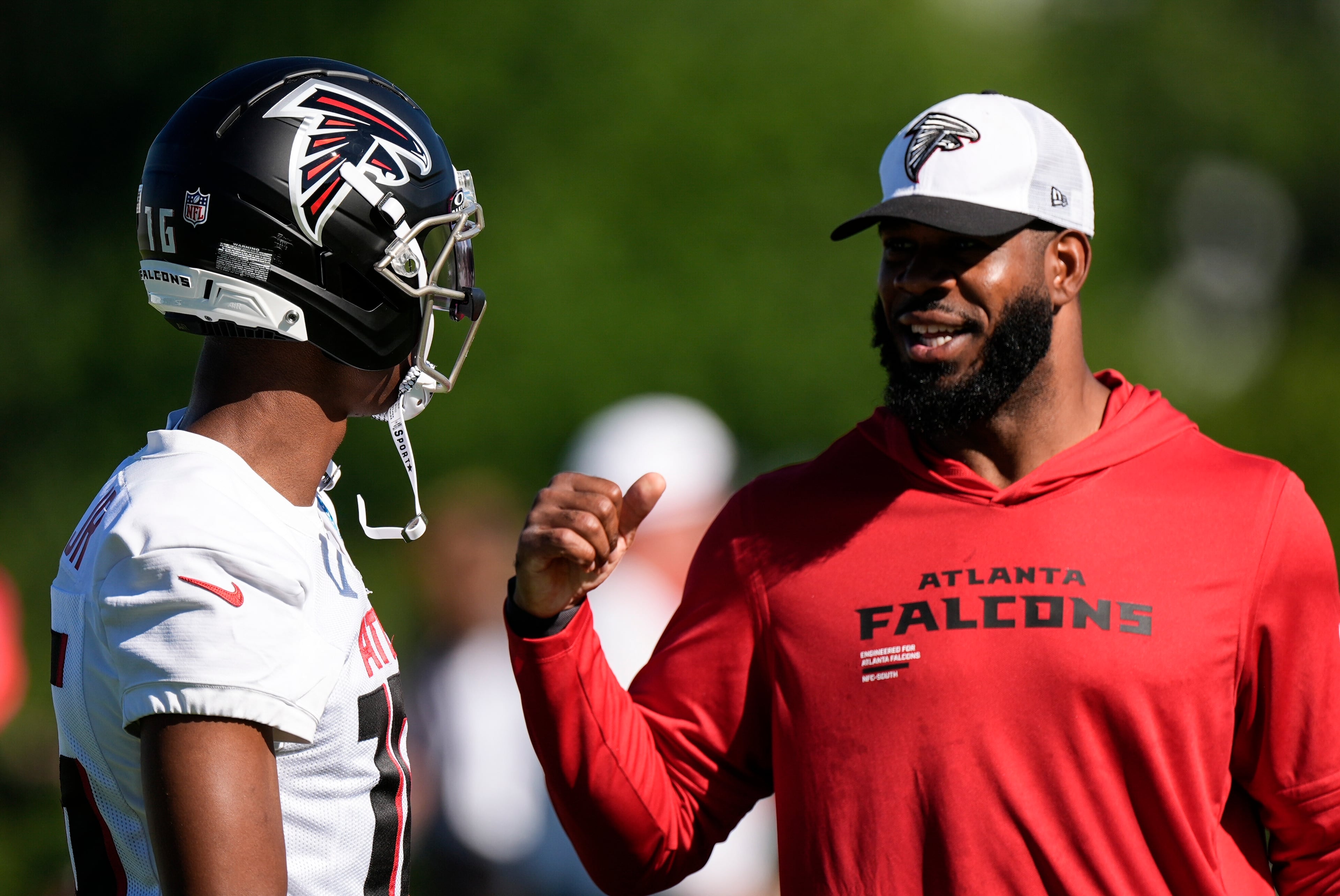 Falcons wide receiver DJ Chark Jr. (left) speaks to tight ends coach Kevin Koger during training camp on Saturday, July 26, 2025, in Flowery Branch. (Mike Stewart/AP)