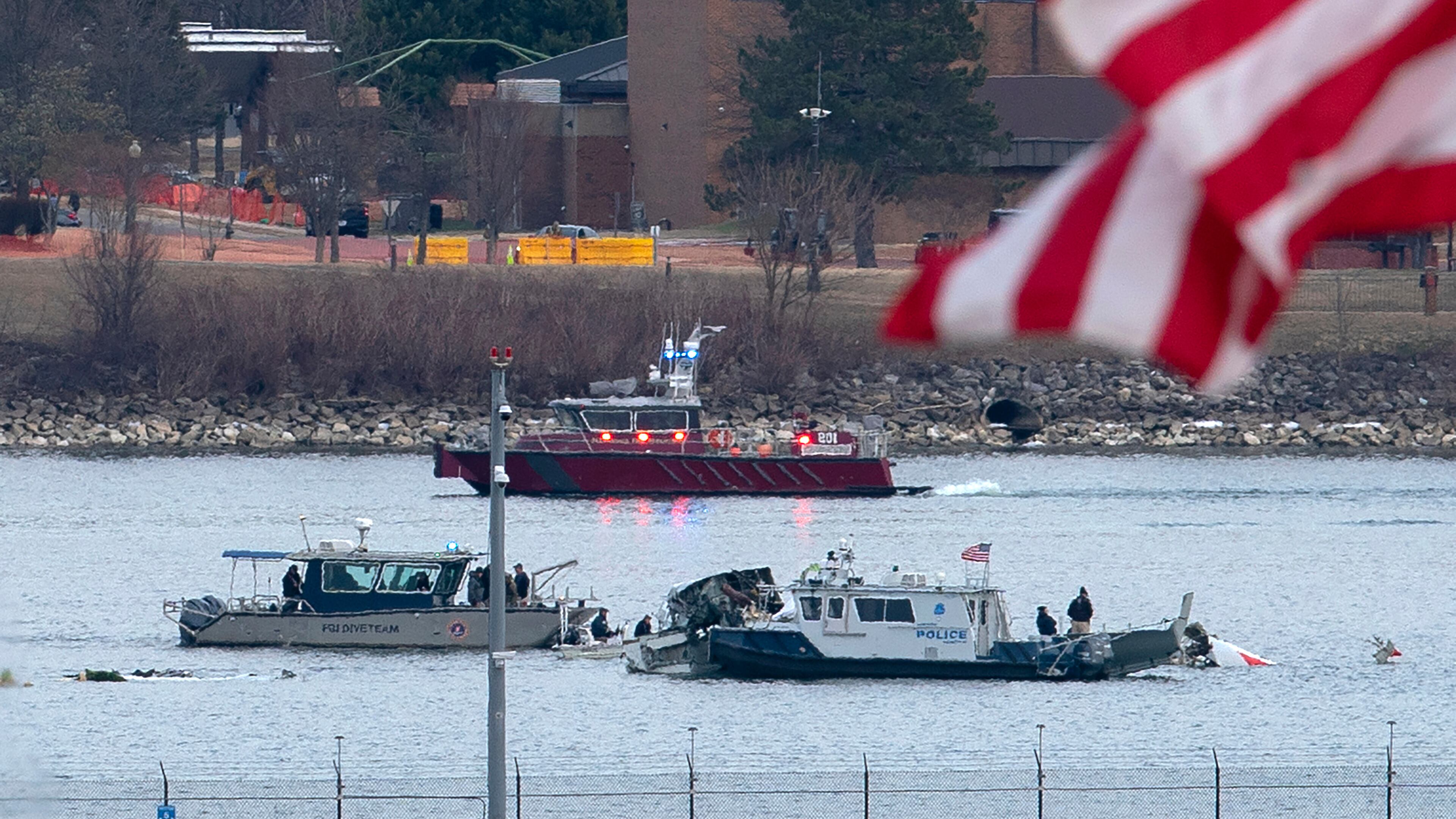 FILE - A diving team and police boat is seen near a wreckage site in the Potomac River, from Ronald Reagan Washington National Airport, Jan. 30, 2025, in Arlington, Va. (AP Photo/Jose Luis Magana, File)