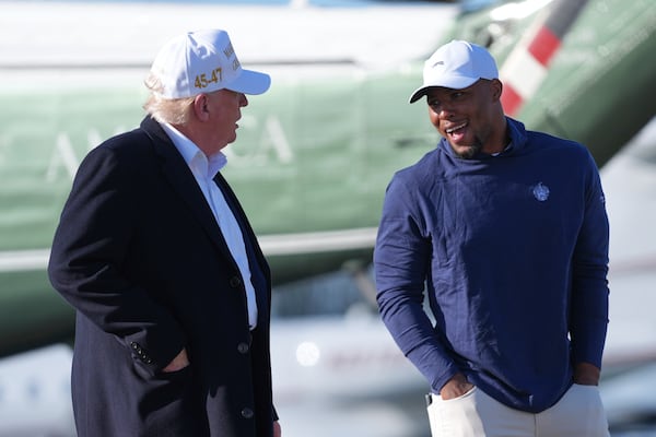 President Donald Trump, left, walks with Philadelphia Eagles football player Saquon Barkley before boarding Air Force One at Morristown Municipal Airport, Sunday, April 27, 2025, in Morristown, N.J. (AP Photo/Evan Vucci)