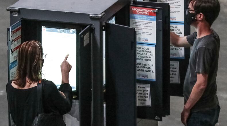 Voters cast their ballots on Oct. 12 at State Farm Arena in downtown Atlanta. Computer scientists, voting-rights activists, U.S. intelligence agencies and a federal judge have repeatedly warned of security deficiencies in Georgia’s system and in electronic voting in general. (John Spink / John.Spink@ajc.com)