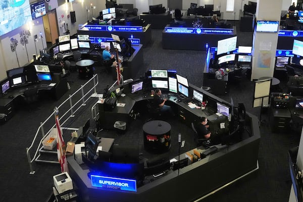 Dispatchers work emergency calls at the Collier County Emergency Services Center, Friday, July 11, 2025, in Naples, Fla. (AP Photo/Marta Lavandier)