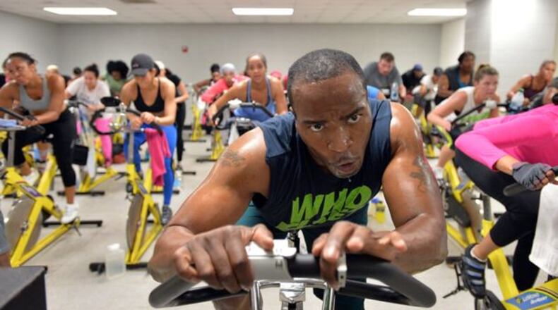 Keith Thompson leads his indoor-cycling class at the Adamsville Recreation Center on Friday, April 4, 2014. At 280 lbs, Keith Thompson wasn’t satisfied with his weight or his health. So, starting with step classes at a local gym, he dedicated his life to fitness and lost over 70 lbs. Several years later, fellow step classmates - who had long since noticed Keith’s contagious energy and positive attitude - suggested that he’d find success as an instructor. HYOSUB SHIN / HSHIN@AJC.COM