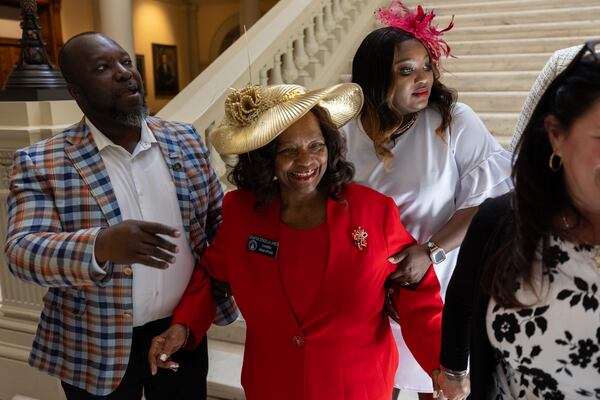 State Sen. Donzella James (center), D-Atlanta, heads to a tea party she sponsored for legislators and employees in the Capitol in Atlanta on Friday.