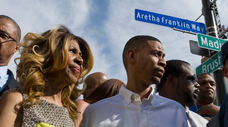 Aretha Franklin and her son Kecalf Cunningham stand under the newly unveiled street sign in front of the Detroit City Music Hall in Detroit, on June 8, 2017.