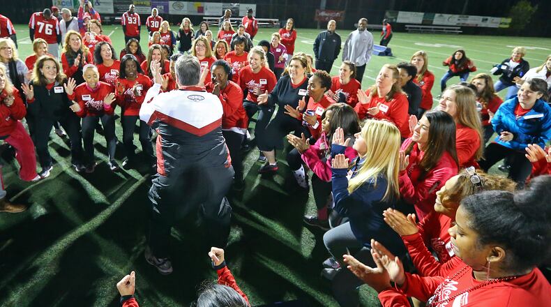 031814 ALPHARETTA: Moms huddle up on the field while the Atlanta Falcons host their first Mom's Football Safety Clinic at Kings Ridge Christian School on Tuesday, March 18, 2014, in Alpharetta. The clinic is designed for moms who have a son/daughter playing youth football and included instruction on proper equipment fitting, heads up tackling techniques, concussion awareness, and on-field drills. CURTIS COMPTON / CCOMPTON@AJC.COM